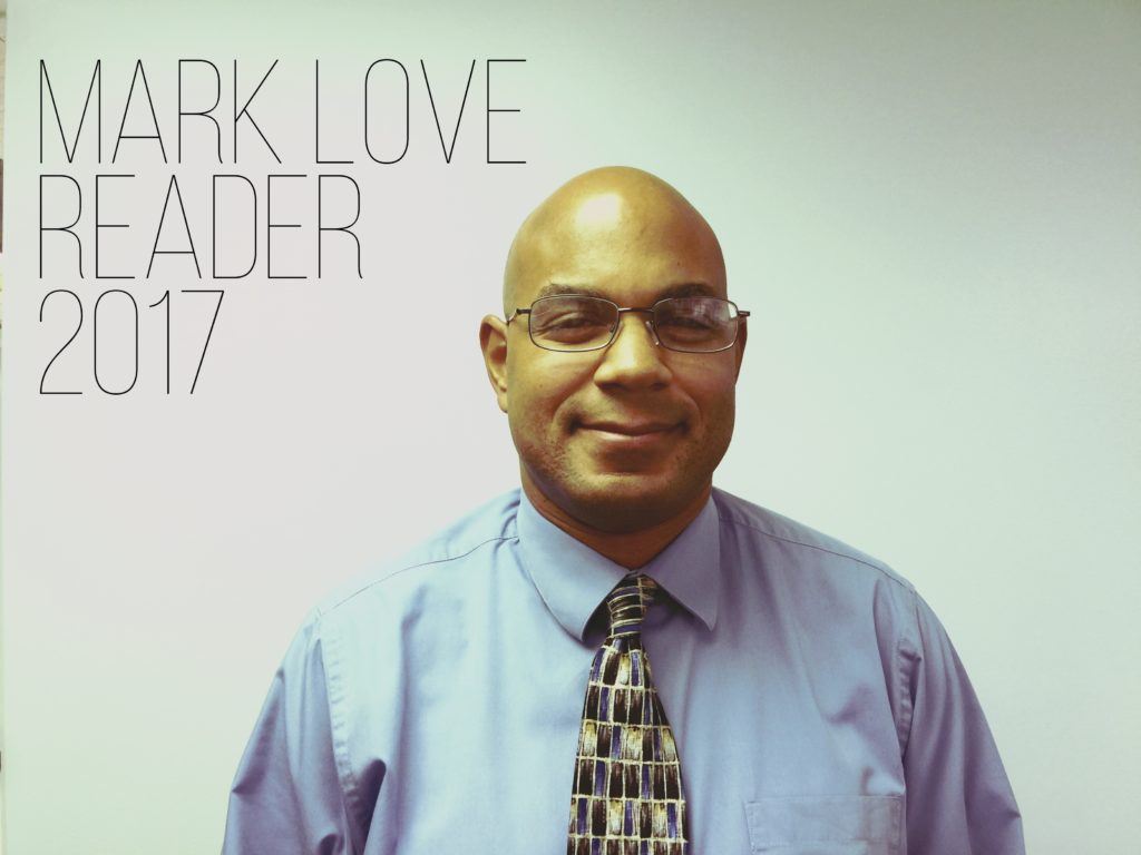Photo of Mark wearing glasses, a button-up shirt and tie. Text - Mark Love, Reader 2017
