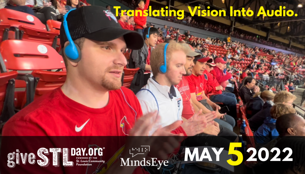 Kyle listens to Cardinals AD at the game. Text: Translating Vision Into Audio. May 5 2022. Give STL Day logo, MindsEye logo