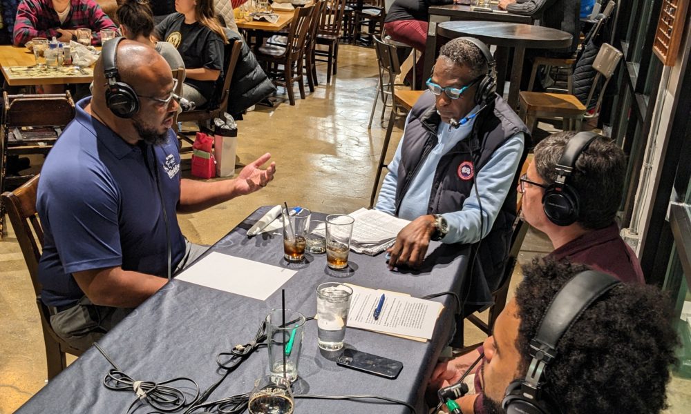 Jason Frazier, Charlie "Tuna" Edwards, Brian Bretsch from Ameren Illinois, and an audio engineer sit around a table at Old Herald Brewing to broadcast the show.