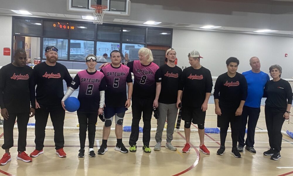 Goalball team standing shoulder to shoulder for a group photo