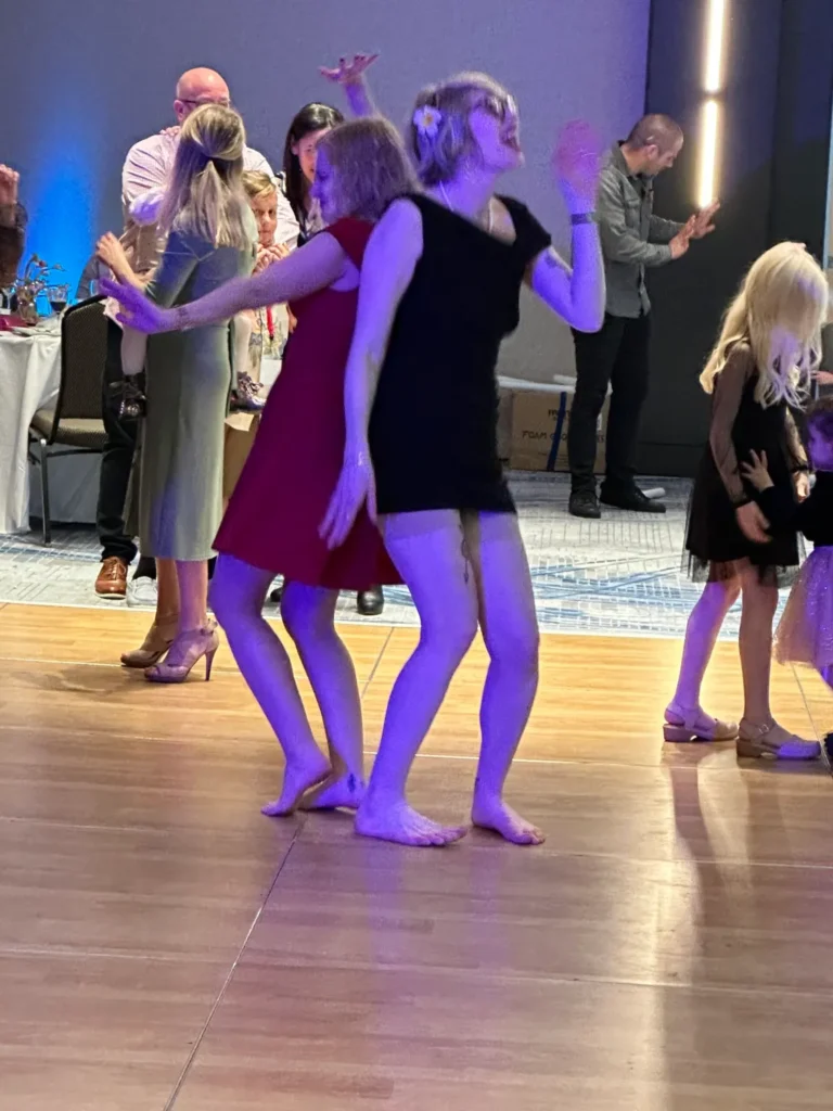 Photo of Casey and Cass dancing on a dance floor. 