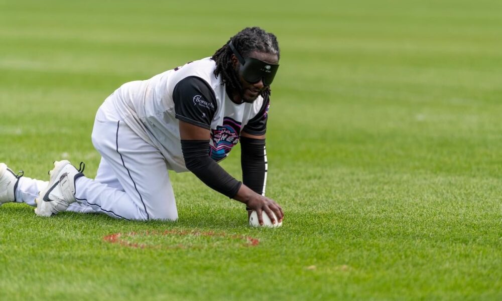 Ethan Johnston fielding a ball on his hands and knees